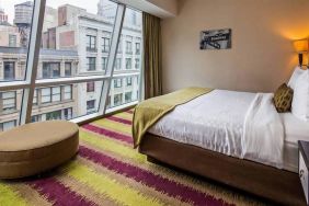 Floor-to-ceiling windows in a double bedroom at the Best Western Premier Herald Square.