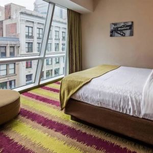 Floor-to-ceiling windows in a double bedroom at the Best Western Premier Herald Square.