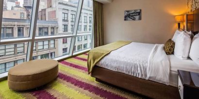 Floor-to-ceiling windows in a double bedroom at the Best Western Premier Herald Square.