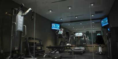 The hotel’s exercise room, with stacked weights and assorted fitness machines.