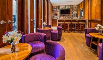 The hotel’s on-site bar, with hard floor and bright purple chairs.