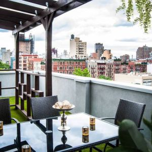 Outdoor terrace with table and chairs for relaxing/socializing.