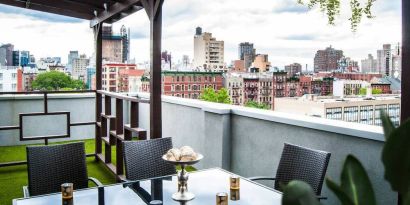 Outdoor terrace with table and chairs for relaxing/socializing.