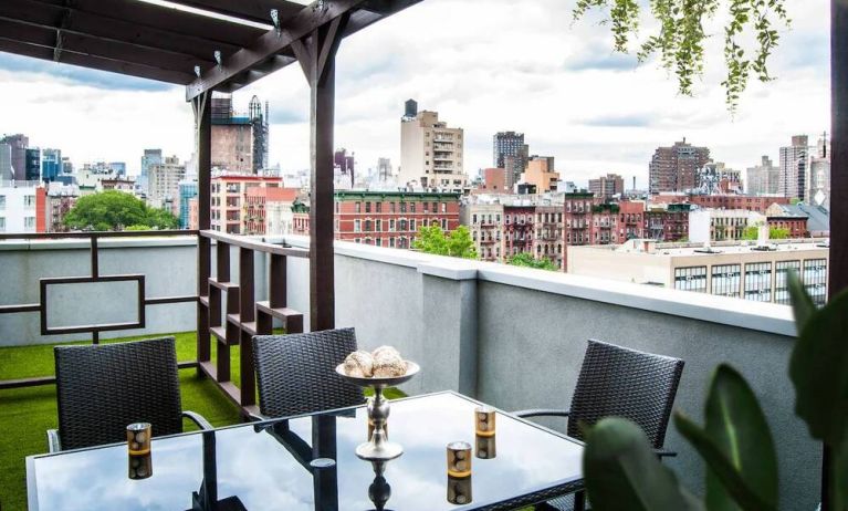 Outdoor terrace with table and chairs for relaxing/socializing.