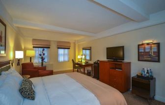 Double bedroom in the San Carlos Hotel, with desk for working, plus window, chair, and television.