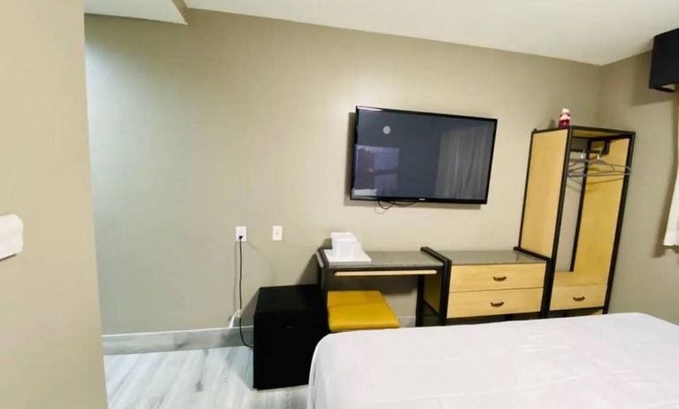 Guest room at the Rodeway Inn Cranston JFK, with space for working and large television.