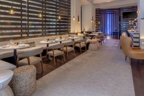 The hotel’s lobby bar, with mix of tall stools at the bar and soft seats around tables.