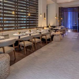 The hotel’s lobby bar, with mix of tall stools at the bar and soft seats around tables.