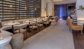 The hotel’s lobby bar, with mix of tall stools at the bar and soft seats around tables.