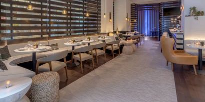 The hotel’s lobby bar, with mix of tall stools at the bar and soft seats around tables.