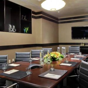 A boardroom-style meeting room within the Hilton Fashion District.