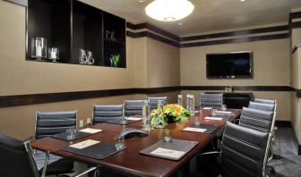 A boardroom-style meeting room within the Hilton Fashion District.