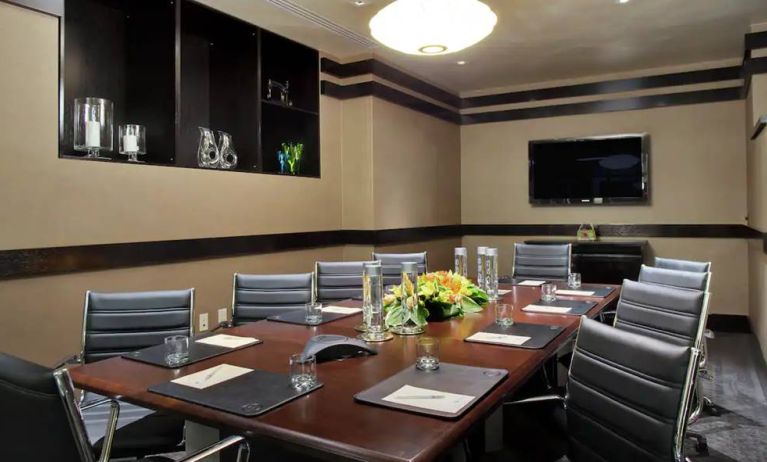 A boardroom-style meeting room within the Hilton Fashion District.