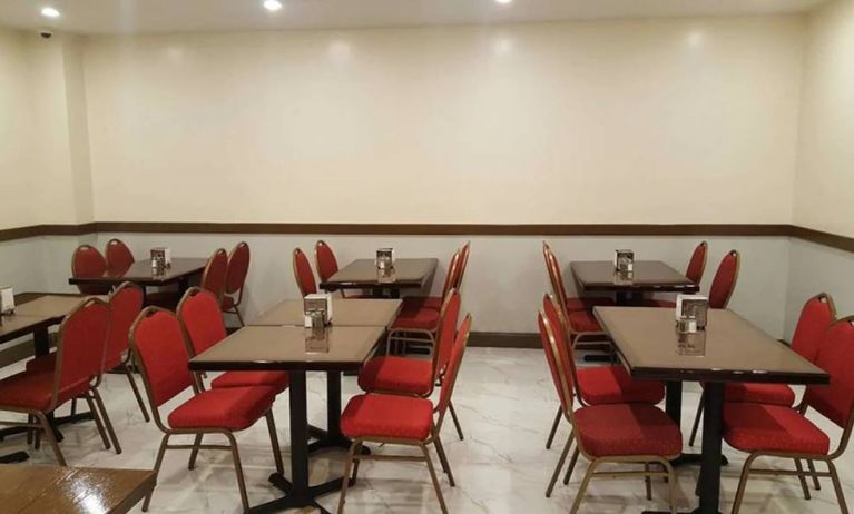 The hotel’s breakfast area, with hard floor and small tables.