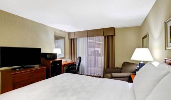 Guest room in Holiday Inn Laval Montreal, featuring workspace desk and chair.