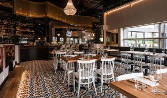 The Holiday Inn Laval Montreal’s on-site restaurant has tall bar stools and table seating.