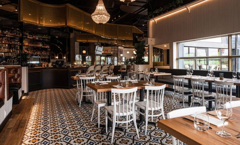 The Holiday Inn Laval Montreal’s on-site restaurant has tall bar stools and table seating.