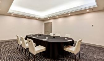 Meeting room with long table and seating for eight around it.