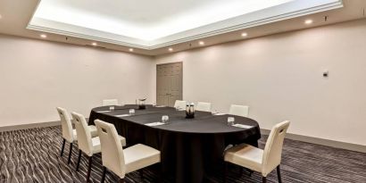 Meeting room with long table and seating for eight around it.