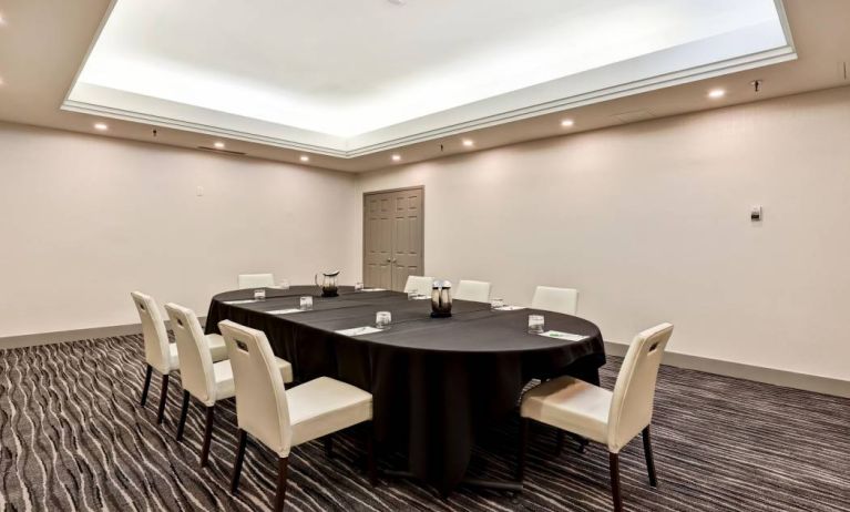 Meeting room with long table and seating for eight around it.