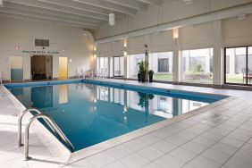 Best Western North Bay’s indoor pool has large window and chairs by the side.