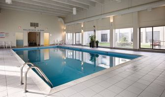 Best Western North Bay’s indoor pool has large window and chairs by the side.