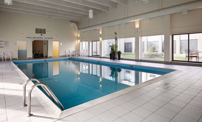 Best Western North Bay’s indoor pool has large window and chairs by the side.