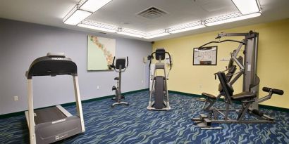 The hotel fitness center is equipped with a variety of exercise machines.