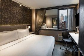 Guest room in the Aliz Hotel Times Square, with double bed and eye-catching city view.