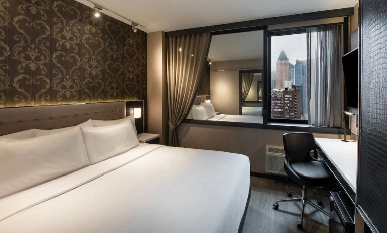 Guest room in the Aliz Hotel Times Square, with double bed and eye-catching city view.