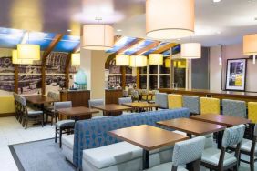 Blue and yellow colorful dining and lounge room at the Hampton Inn Manhattan - Madison Square Garden.