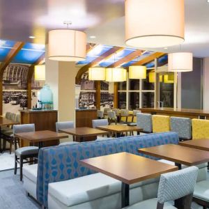 Blue and yellow colorful dining and lounge room at the Hampton Inn Manhattan - Madison Square Garden.