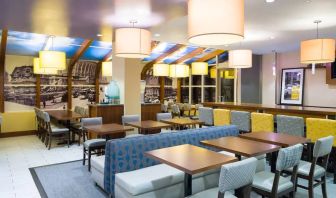 Blue and yellow colorful dining and lounge room at the Hampton Inn Manhattan - Madison Square Garden.