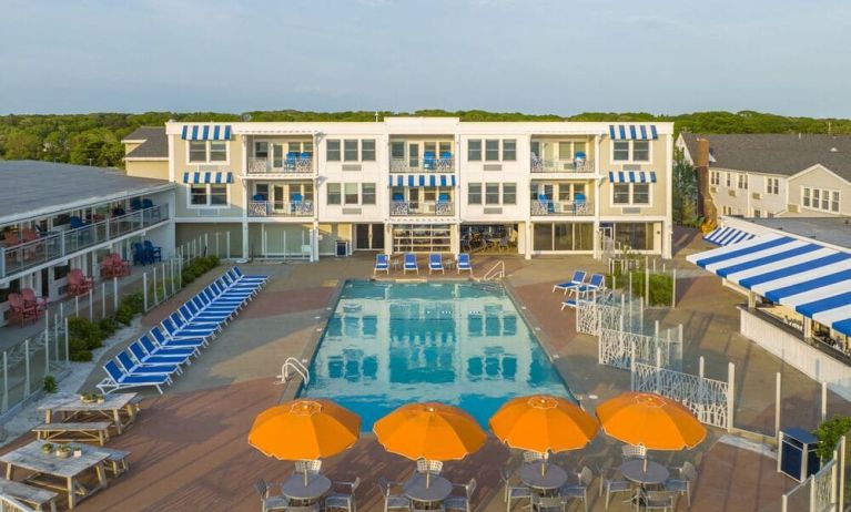 Outdoor pool with lounge chairs and umbrellas at Sea Crest Beach Hotel.