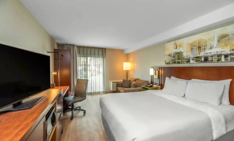 Comfort Inn Winnipeg Airport guest room including double bed and large television.