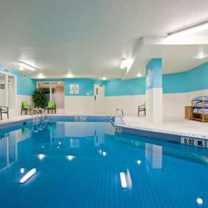 The hotel’s indoor swimming pool has nearby chairs and towels.