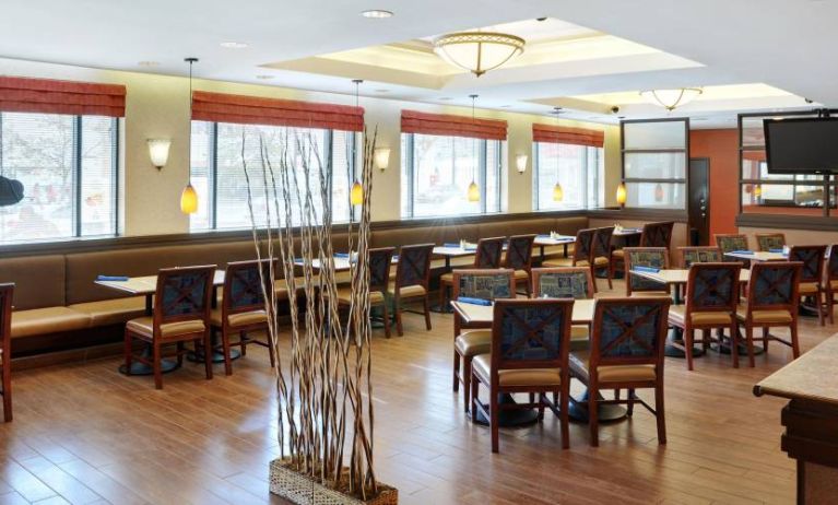 Peppermill Cafe is the hotel’s on-site dining venue, with tables for four and large windows.