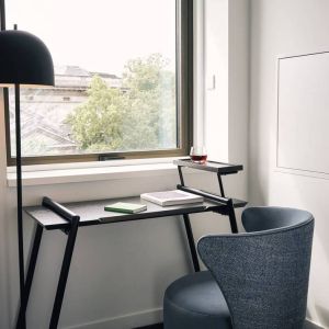 A little workspace, with desk, lamp, and window to ensure an abundance of light.