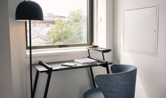 A little workspace, with desk, lamp, and window to ensure an abundance of light.