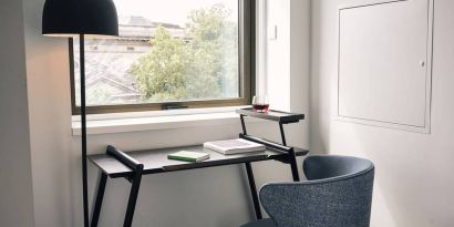 A little workspace, with desk, lamp, and window to ensure an abundance of light.