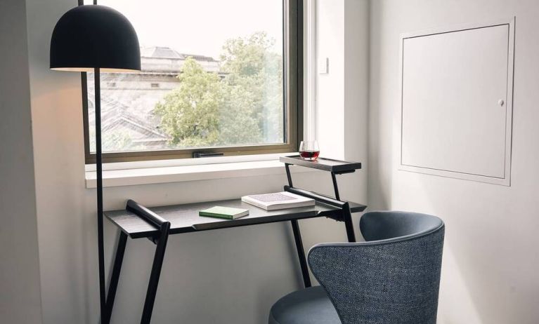 A little workspace, with desk, lamp, and window to ensure an abundance of light.