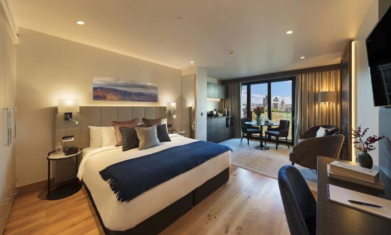 Large double bedroom in the Tower Suites By Blue Orchid Hotels, with workspace, window, and kitchenette.