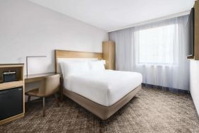 Guest room in the DoubleTree Times Square South, with double bed and workspace desk and chair.