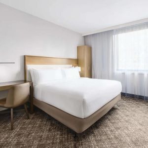 Guest room in the DoubleTree Times Square South, with double bed and workspace desk and chair.