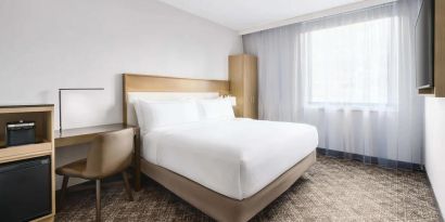 Guest room in the DoubleTree Times Square South, with double bed and workspace desk and chair.