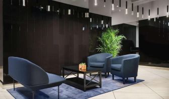 The hotel’s lobby, with comfortable chairs and sofa, plus coffee table.