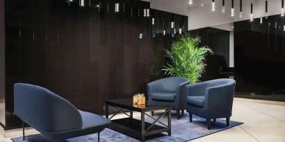 The hotel’s lobby, with comfortable chairs and sofa, plus coffee table.