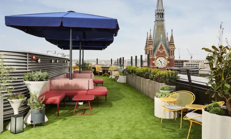 Rooftop seating, green astroturf, and the St. Pancras Clock Tower looming in the background skyline.