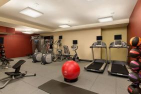 The hotel fitness center where guests can use exercise machines, balls, and weights.