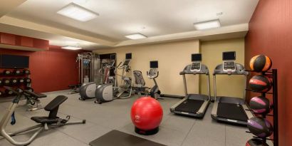 The hotel fitness center where guests can use exercise machines, balls, and weights.